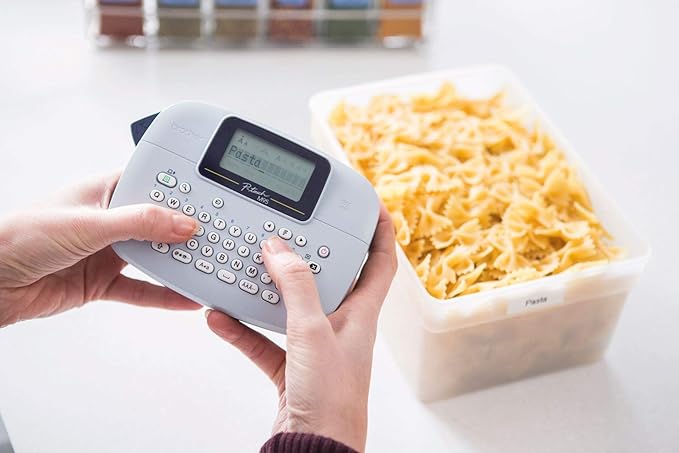 Brother PT-M95 Label Maker, P-Touch Label Printer, Handheld, QWERTY Keyboard, Up to 12mm Labels, Includes Black on White Tape Cassette